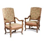 A PAIR OF FRENCH OAK OPEN ARMCHAIRS IN REGENCE STYLE LATE 19TH CENTURY each with a needlework padded