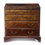 A GEORGE II WALNUT BACHELOR'S CHEST c.1740 the quarter veneered and crossbanded top inlaid with a