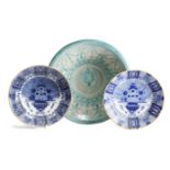 TWO SIMILAR DUTCH DELFT BLUE AND WHITE CHARGERS LATE 18TH CENTURY each painted with an urn of
