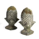 A PAIR OF COMPOSITE STONE GARDEN FINIALS in the form of pineapples (2) 45cm high