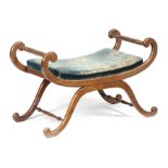A MAHOGANY WINDOW SEAT IN REGENCY STYLE the scroll and 'X' shape frame with an upholstered seat