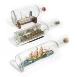 THREE SHIPS IN A BOTTLE EARLY 20TH CENTURY AND LATER one depicting a four-masted sailing ship before