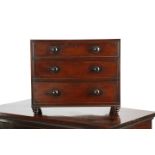 A 19TH CENTURY MAHOGANY CHILD'S CHEST C.1840 of three long drawers, on inverted beehive feet 51.