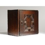 A CHARLES II OAK HANGING SPICE CUPBOARD LATE 17TH CENTURY with punched star decoration, the hinged