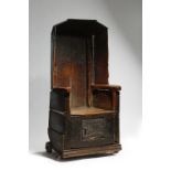 A WELSH PRIMITIVE ELM LAMBING / COMMODE CHAIR 17TH / 18TH CENTURY AND LATER the hooded top above a