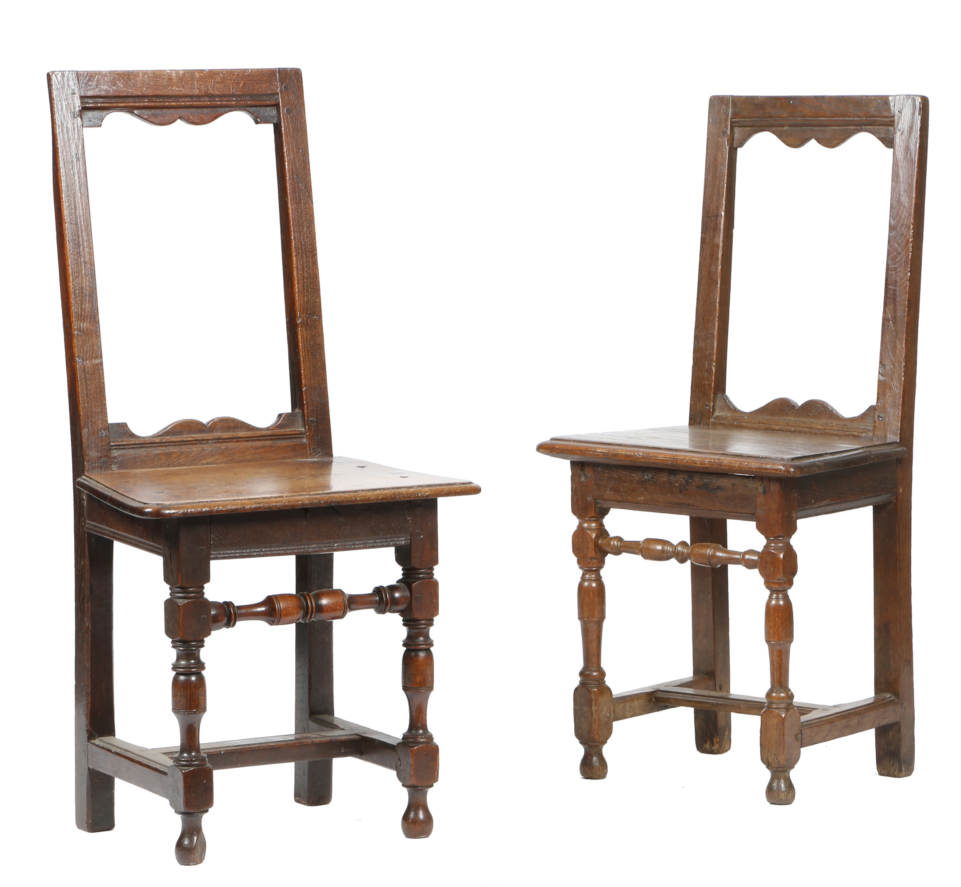 TWO SIMILAR OAK BACKSTOOLS EARLY 18TH CENTURY each with an open back with arc d'arbelete rails above