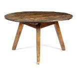 A VICTORIAN PINE CRICKET TABLE LATE 19TH CENTURY the circular boarded top on tapering legs 72.7cm