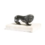 AN ITALIAN BRONZE GRAND TOUR MODEL OF A PACING LION mounted on a white marble base 12cm wide