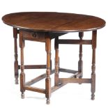 A GATELEG TABLE EARLY 18TH CENTURY AND LATER the later red walnut drop-leaf oval top on an oak