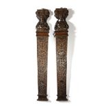 A PAIR OF 17TH CENTURY CARVED OAK CARYATYDS OR TERMS c.1620 each with a male figure supporting an