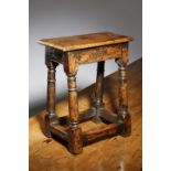 A YEW JOINT STOOL WITH 17TH CENTURY ELEMENTS the seat with a moulded edge above a plain frieze, on