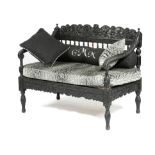 AN ANGLO-INDIAN EBONISED HARDWOOD SETTEE POSSIBLY GOAN, 19TH CENTURY carved with scrolling leaves