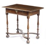 A QUEEN ANNE OAK SIDE TABLE EARLY 18TH CENTURY the boarded top with a moulded edge, above a frieze