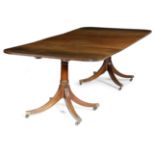 A MAHOGANY TWIN PEDESTAL DINING TABLE IN REGENCY STYLE 20TH CENTURY the reeded edge top with two