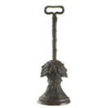 A VICTORIAN PATINATED BRASS DOORSTOP in the form of a wheatsheaf, the wreath handle above a rope