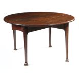 A GEORGE II MAHOGANY DINING TABLE c.1740-50 the oval drop-leaf top above turned club legs and pad