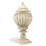 AN ITALIAN CARVED ALABASTER URN AND COVER LATE 19TH CENTURY of fluted baluster shape, with egg and