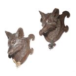 TWO BLACK FOREST CARVED WOOD WALL HANGING COAT RACKS each carved with a fox's head, on a shaped