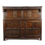 AN OAK PRESS CUPBOARD 17TH CENTURY AND LATER the frieze carved with stylised scrolls, initials '