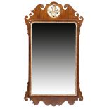 A GEORGE II WALNUT AND PARCEL GILT FRET FRAME WALL MIRROR the bevelled plate with arched top