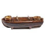 A VICTORIAN POTTERY INKSTAND IN THE FORM OF A BARGE LATE 19TH CENTURY with a treacle glaze, with