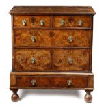 A QUEEN ANNE WALNUT CHEST ON STAND EARLY 18TH CENTURY the quarter veneered top with cross and