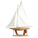 A LARGE POND YACHT LATE 19TH / EARLY 20TH CENTURY with a clinker built hull, cotton sails and