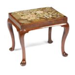 A GEORGE I WALNUT STOOL EARLY 18TH CENTURY with cusped corners, the later floral needlework drop-