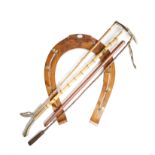 A WALNUT HORSE SHOE SHAPE HANGING WHIP RACK BY MAXWELL FIRST HALF 20TH CENTURY with brass hooks