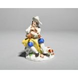 A miniature Meissen figure of a musician, 20th century, seated on a rocky stump and playing the