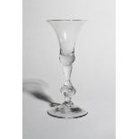 A baluster wine glass, c.1740, with a bell bowl raised on a baluster stem with a large knop