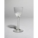 A wine glass, c.1760-65, the ogee bowl moulded with a honeycomb design to the base, raised on a