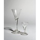 A gin glass and a wine glass, c.1760-70, each with a drawn trumpet bowl above a plain stem, the wine