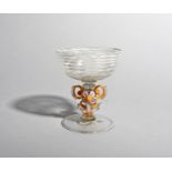 A Venetian glass or winged goblet, probably 18th century, the wide shallow bowl with 'combed'