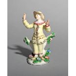 A rare Bow figure of Pedrolino or Pierrot, c.1755, from the Commedia dell'Arte, wearing a yellow