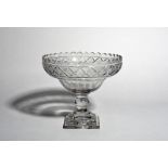 A large Irish cut glass footed bowl, 19th century, of ogee form, cut with a narrow diamond band