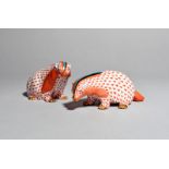 A pair of Herend models of badgers, modern, each decorated with stripes of red, blue, black and gilt