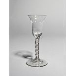 A coloured twist wine glass, c.1760, with a bell bowl raised on a stem enclosing blue, red, green