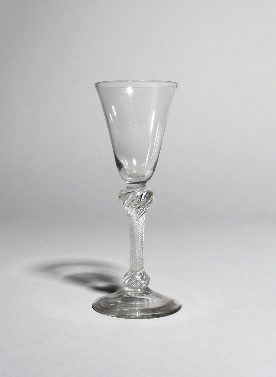 A wine glass, c.1760-70, with a rounded funnel bowl raised on an airtwist stem knopped at the