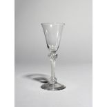 A wine glass, c.1760-70, with a rounded funnel bowl raised on an airtwist stem knopped at the