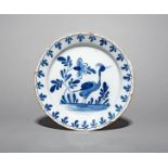 A delftware plate, mid 18th century, probably Bristol, painted in blue with a standing crane or