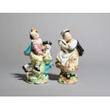 A rare pair of Derby figures of a boy and girl with a Macaroni dog and cat, c.1775, the boy half