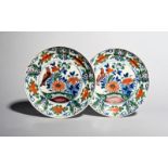 A pair of delftware plates, c.1710-20, possibly London, painted in blue, green, red and manganese,
