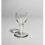 A firing or dram glass, c.1760, with a rounded funnel bowl raised on a double series opaque twist