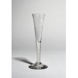 A ratafia glass, c.1755-60, the slender drawn bowl with a band of vertical moulded flutes, raised on