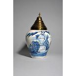 A Delft tobacco jar, 18th/19th century, painted with a native American Indian sitting on a plinth