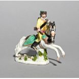 A miniature Meissen figure of a Hussar, mid 18th century, modelled on horseback, his gun in his