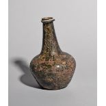 An English wine bottle, c.1660-70, of shaft and globe type, the tapering neck with a significant