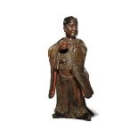 A CHINESE LACQUERED AND GILT-WOOD FIGURE OF A DIGNITARY 16TH CENTURY He stands with his feet apart