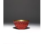 A RARE CHINESE IMPERIAL CINNABAR LACQUER 'WAN SHOU WU JIANG' TEA BOWL FOUR CHARACTER QIANLONG MARK